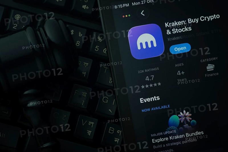 Dhaka, Bangladesh- 28 Oct 2025: An iPad displaying the Kraken app against a judge's gavel and dark keyboard background