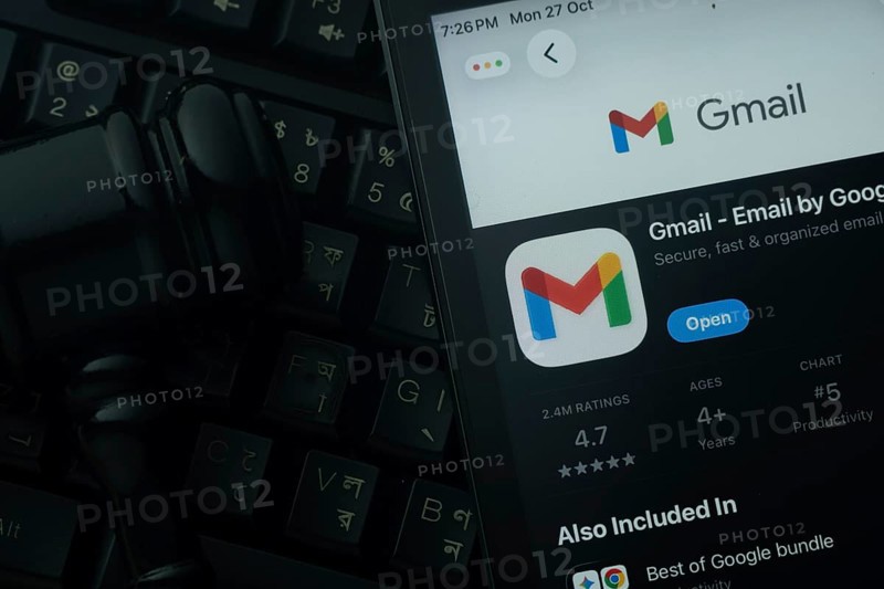 Dhaka, Bangladesh- 28 Oct 2025: An iPad displaying the Gmail app against a judge's gavel and dark keyboard background