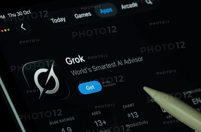 Dhaka, Bangladesh- 30 Oct 2025: Grok Ai app displayed on a iPad screen in dark mode with a digital pen pointing at it