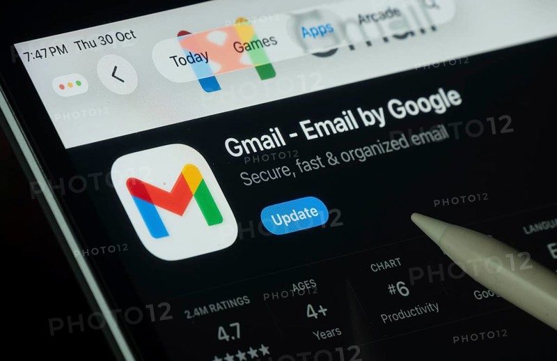 Dhaka, Bangladesh- 30 Oct 2025: Gmail app displayed on a iPad screen in dark mode with a digital pen pointing at it