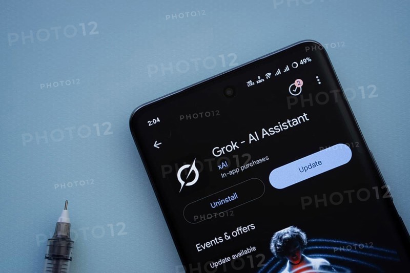 Dhaka, Bangladesh- 29 May 2025: On a blue surface, a smartphone displays the Grok Ai app within the Google Play Store