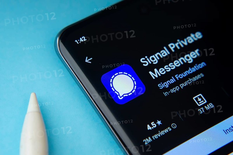 Dhaka, Bangladesh- 29 May 2025: On a blue surface, a smartphone displays the Signal app within the Google Play Store