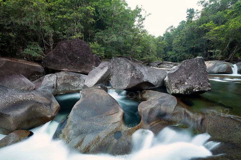 Turquoise blue water between rocks in the tropical rainforest of Babinda Boulders Queensland Australia