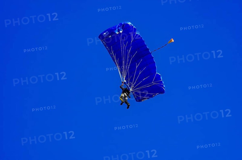 Skydivers during an aerial acrobatic performance as part of an air show at the Fliegerbergfest of the Rossfeld Luftsportverein in Metzingen-Glems, Baden-Württemberg, Germany, for editorial use only