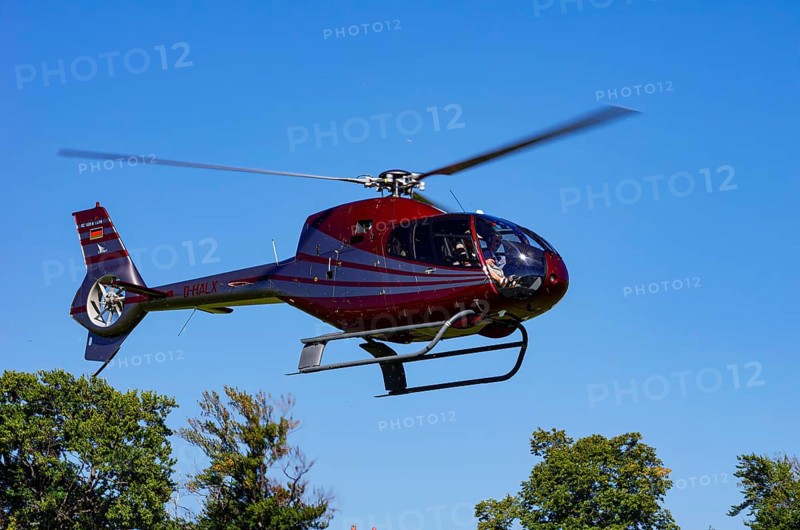 A Eurocopter EC 120B Colibri helicopter, D-HALX registration, during a flight demonstration as part of an air show on Rossfeld in Metzingen-Glems, Baden-Württemberg, Germany, for editorial use only