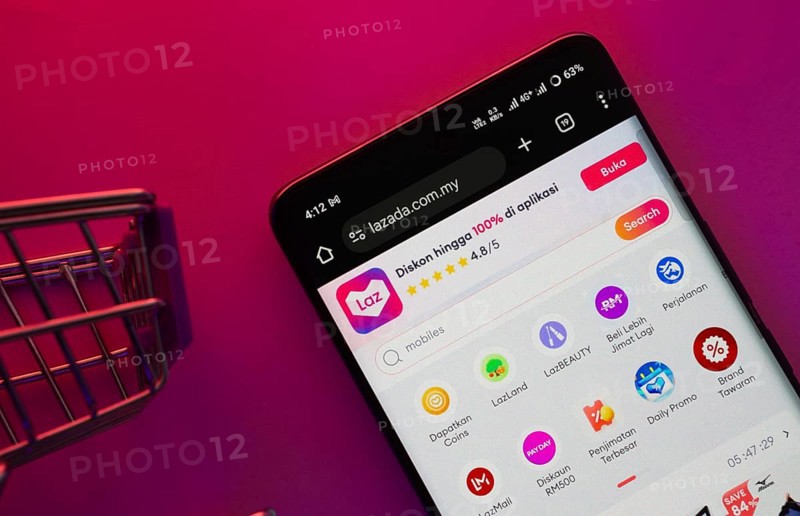 Dhaka, Bangladesh- 23 June 2025: A smartphone displaying the Lazada website with a shopping cart is shown on a vibrant background