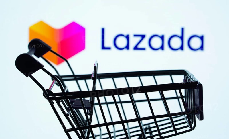 Dhaka, Bangladesh- 03 July 2025: Silhouette of a shopping cart in front of the Lazada logo, symbolizing ecommerce and online shopping