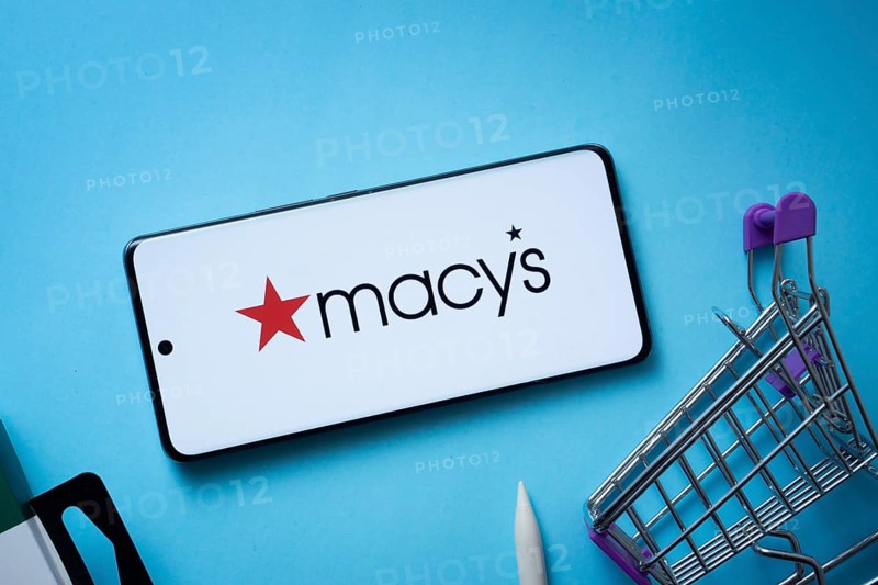Dhaka, Bangladesh- 03 July 2025: Smartphone displaying Macy's logo with shopping cart on a blue background