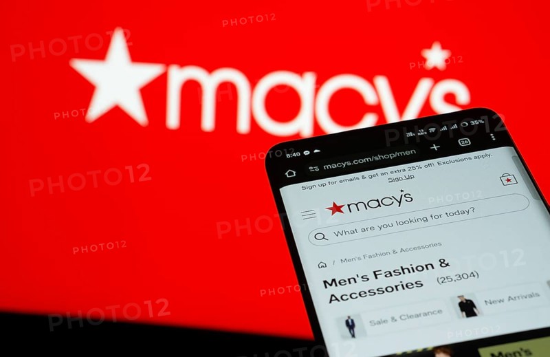 Dhaka, Bangladesh- 03 July 2025: Smartphone displaying Macy's web interface against Macy's logo background