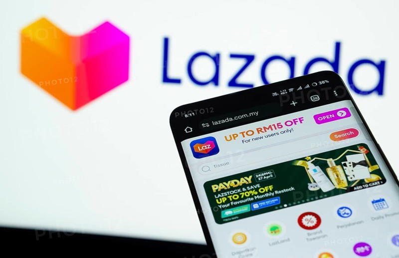 Dhaka, Bangladesh- 03 July 2025: Smartphone displaying Lazada web interface against Lazada logo background