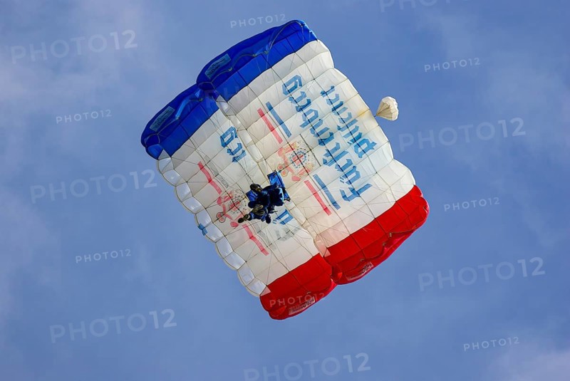 Two parachutists during an aerial acrobatic performance as part of an air show at the Rossfeld in Metzingen-Glems, Baden-Württemberg, Germany, for editorial use only