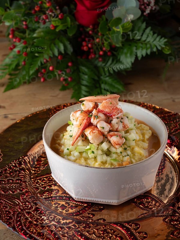 Gourmet lobster risotto with diced vegetables served on a decorative plate