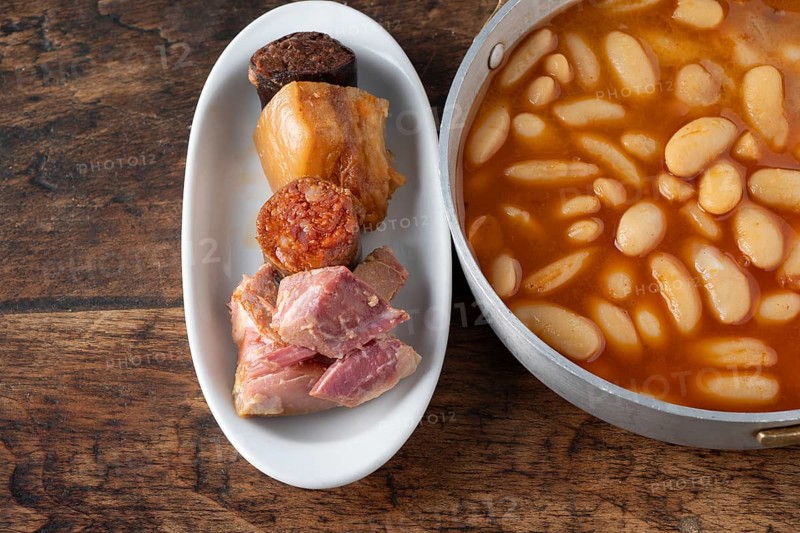 Fabada asturiana, a traditional spanish bean stew with various pork products