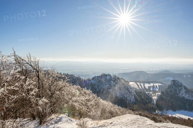 View over the hills and valleys from the mountain with hoarfrost on the branches in winter, Vápec, Horná Poruba, Slovakia