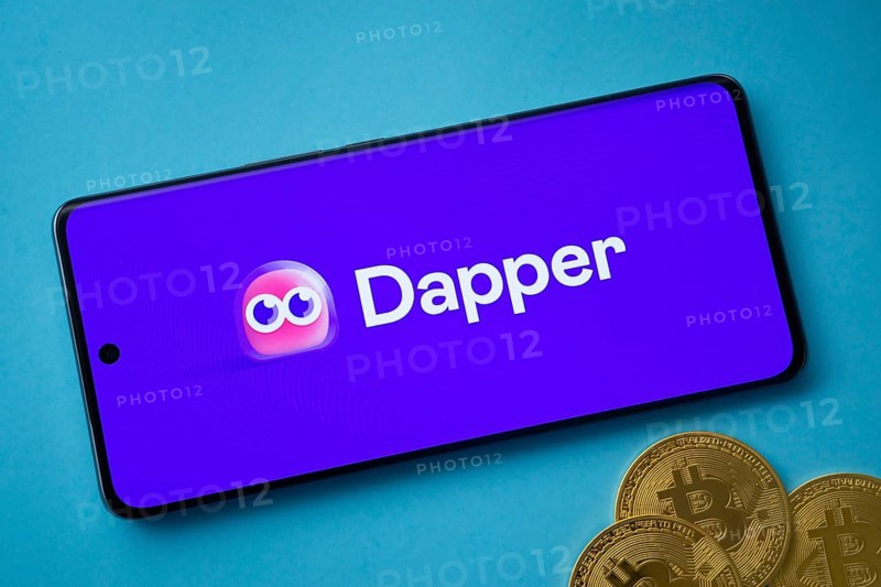 Dhaka, Bangladesh- 03 Oct 2025: Dapper logo on smartphone screen near Bitcoin coin and QR code on blue background