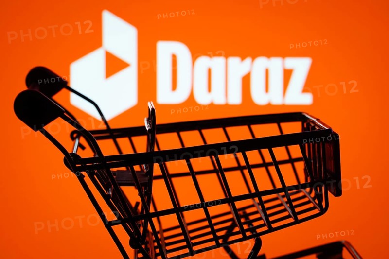 Dhaka, Bangladesh- 03 Oct 2025: Silhouette of a shopping cart in front of the Daraz logo, symbolizing ecommerce and online shopping