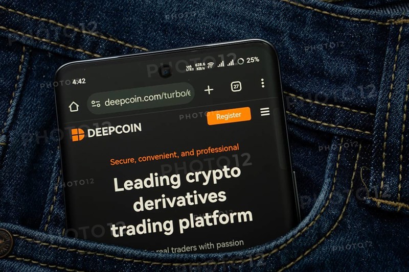 Dhaka, Bangladesh- 03 Oct 2025: A smartphone displaying the Deepcoin web interface peeks out of a denim pocket