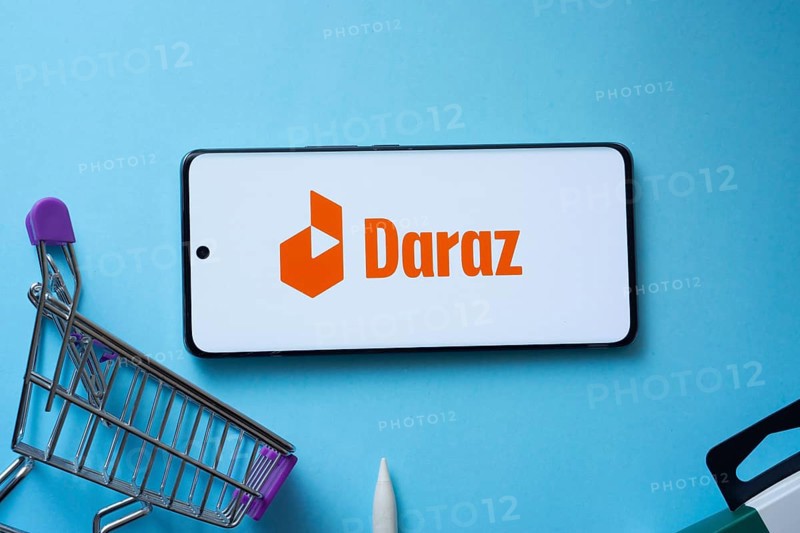 Dhaka, Bangladesh- 03 Oct 2025: Smartphone displaying Daraz logo with shopping cart on a blue background