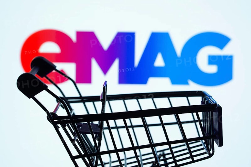 Dhaka, Bangladesh- 03 Oct 2025: Silhouette of a shopping cart in front of the Emag logo, symbolizing ecommerce and online shopping