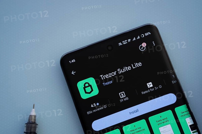 Dhaka, Bangladesh- 30 Sep 2025: On a blue surface, a smartphone displays the Trezor app with in the Google Play Store