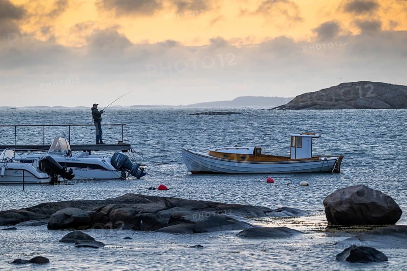 Small bay, archipelago, jetty with angler, Resö Island, Bohuslän, Skagerrak, Sotenäs, Västra Götalands län, Sweden