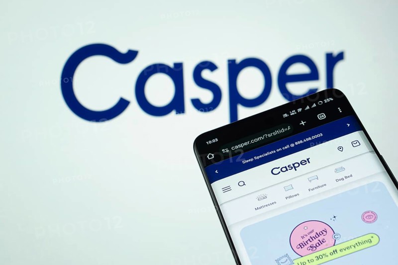 Dhaka, Bangladesh- 03 July 2025: Smartphone displaying Casper web interface against Casper logo background