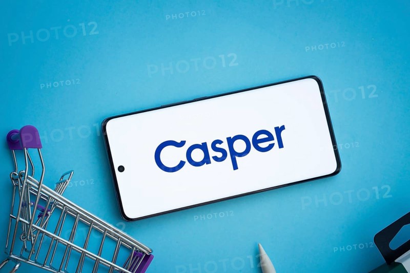 Dhaka, Bangladesh- 03 July 2025: Smartphone displaying Casper logo with shopping cart on a blue background