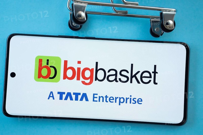Dhaka, Bangladesh- 03 July 2025: Smartphone screen showing the BigBasket logo with shopping cart wheels on a blue background
