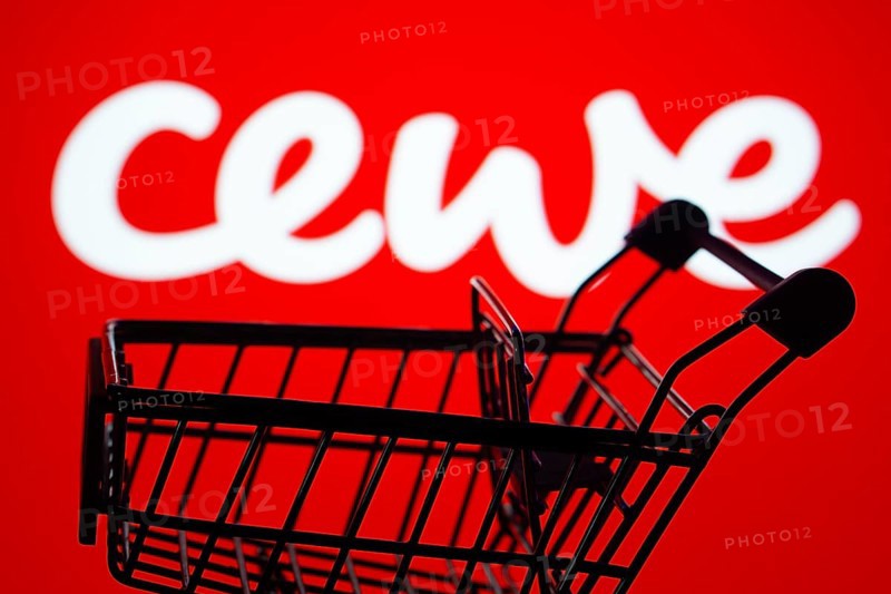 Dhaka, Bangladesh- 03 July 2025: Silhouette of a shopping cart in front of the Cewe logo, symbolizing ecommerce and online shopping
