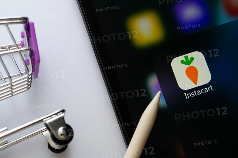 Dhaka, Bangladesh- 05 Sep 2025: A close up of an iPad screen displaying the instacart app alongside a mini shopping cart