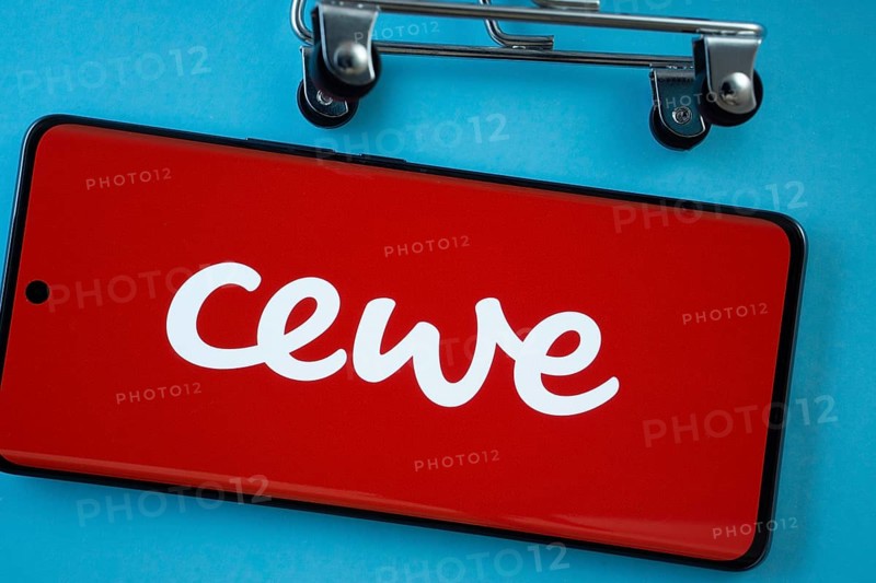 Dhaka, Bangladesh- 03 July 2025: Smartphone screen showing the Cewe logo with shopping cart wheels on a blue background