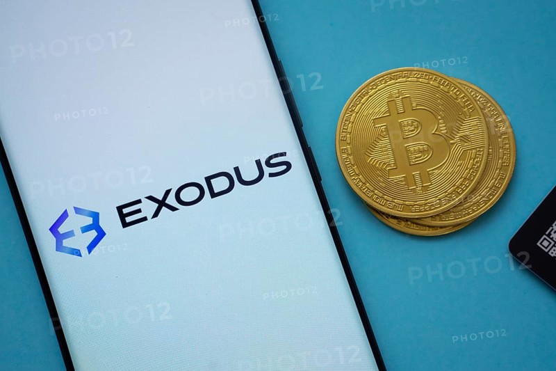 Dhaka, Bangladesh- 06 Sep 2025: Exodus logo on smartphone screen near Bitcoin coin and QR code on blue background