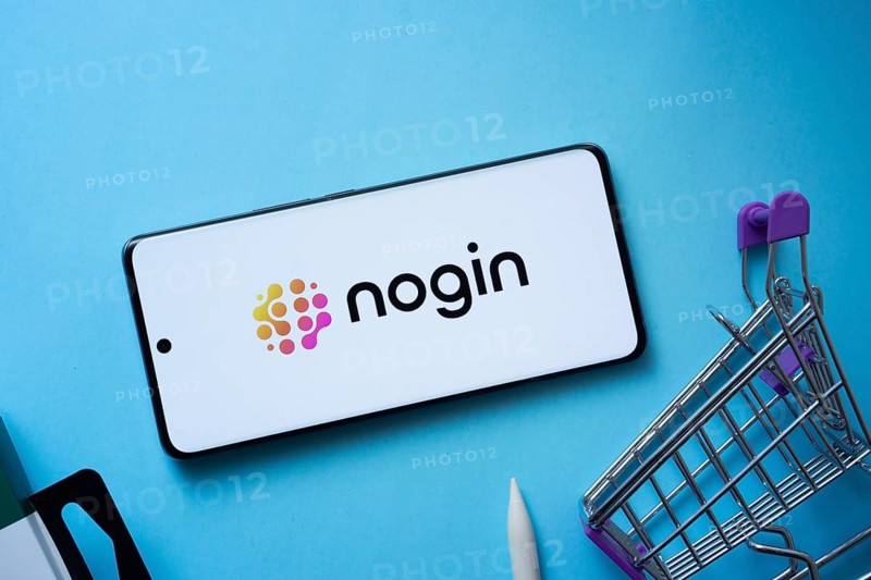 Dhaka, Bangladesh- 03 July 2025: Smartphone displaying nogin logo with shopping cart on a blue background