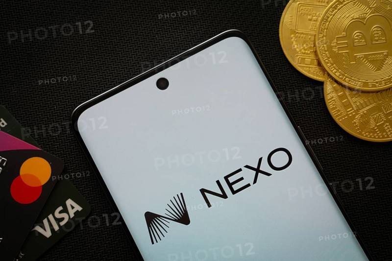 Dhaka, Bangladesh- 06 Sep 2025: Smartphone displaying nexo logo surrounded by Bitcoin coins and payment cards