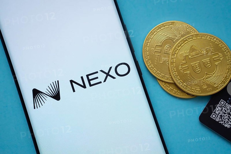 Dhaka, Bangladesh- 06 Sep 2025: Nexo logo on smartphone screen near Bitcoin coin and QR code on blue background