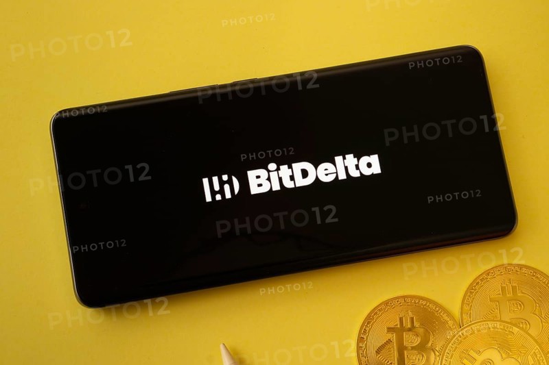 Dhaka, Bangladesh- 02 June 2025: BigDelta logo on smartphone screen near Bitcoin coin and QR code on background
