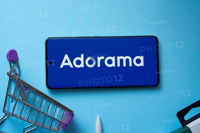Dhaka, Bangladesh- 03 July 2025: Smartphone displaying Adorama logo with shopping cart on a blue background