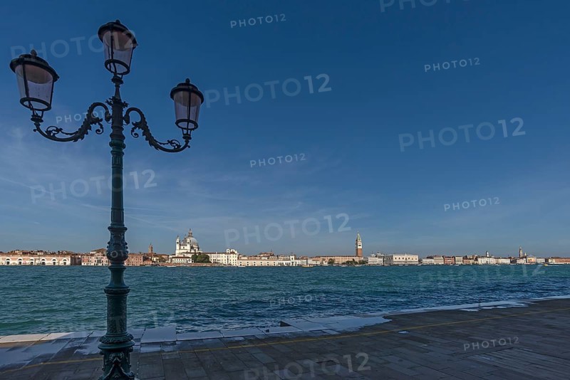 View of Venice from the island of San Giorgio Maggiore, with the church of Santa Maria della Salute and St Mark's Tower, in front the Venetian lagoon, Venice, Veneto, Italy
