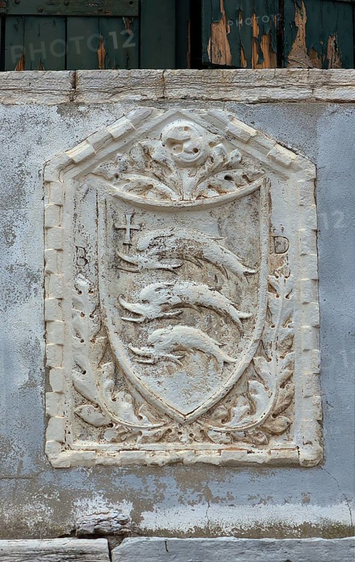 Coat of arms with three dolphins on a house wall, Venice, Veneto, Italy