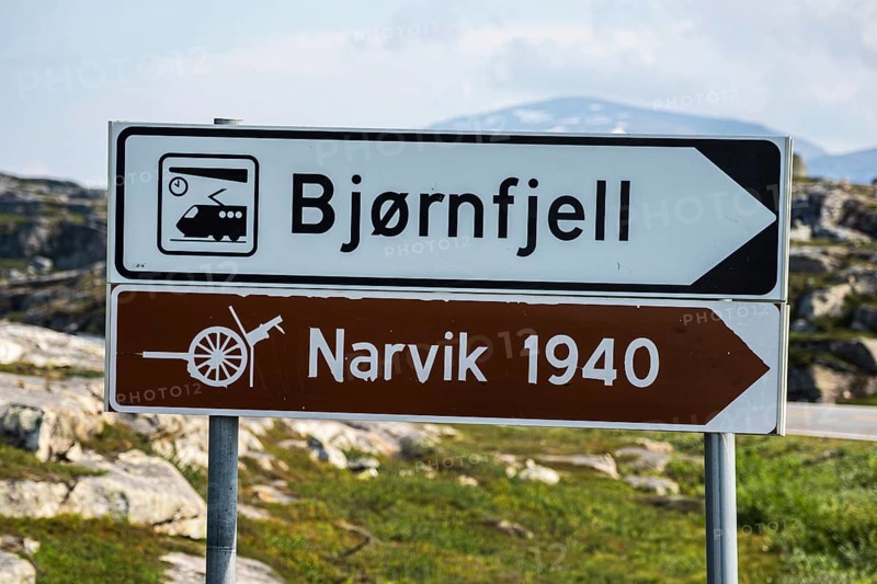 Signpost to Bjørnfjell railway station, railway line Kiruna-Narvik, and world war II memorial, battle of Narvik 1940, Norway