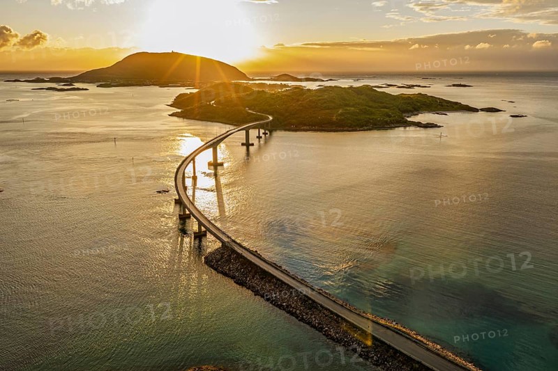 Sommaroy Bridge connecting Kvaloya Island to Sommaroy Island, warm light at sunset, aerial view, Norway