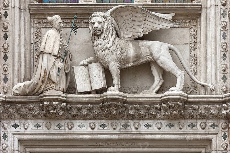 Doge kneels in front of St. Mark's Lion above the Porta della Carta of the Doge's Palace, Venice, Veneto, Italy