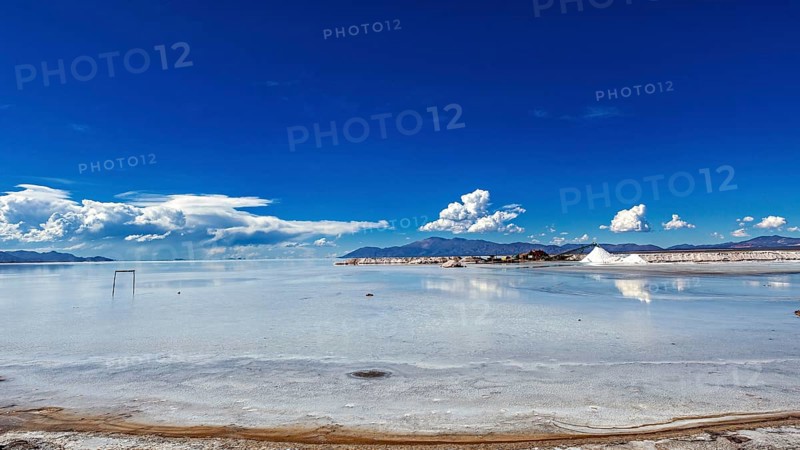 Wide view of a salt lake with blue sky and few clouds, The Salar de Cauchari salt pan near Salta in Argentina