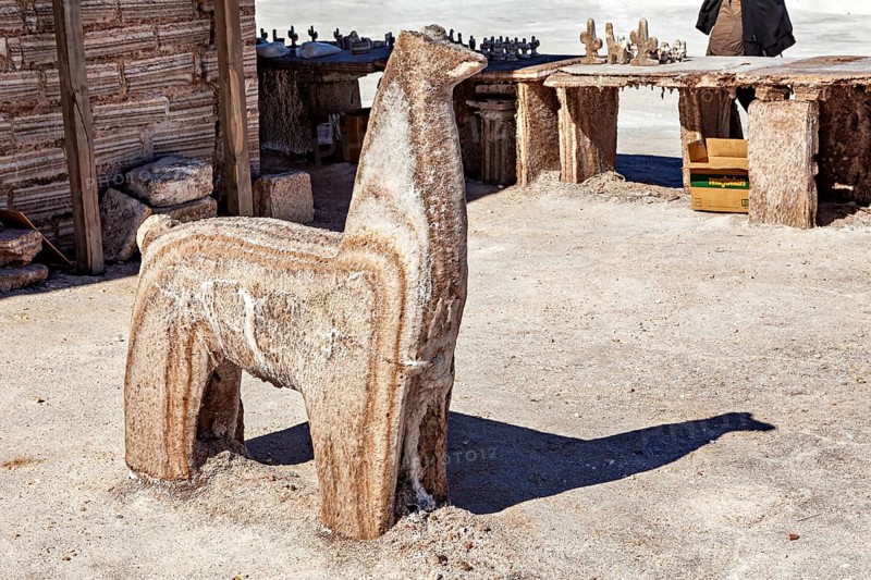 Salt sculpture of an alpaca in a rustic, bright desert environment, salt sculptures in the Salar de Cauchari salt pan near Salta in Argentina