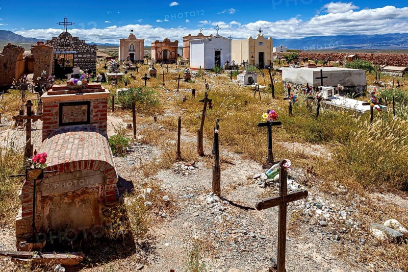 Old cemetery with graves and crosses under a blue sky with clouds, The cemetery of Cachi in Argentina