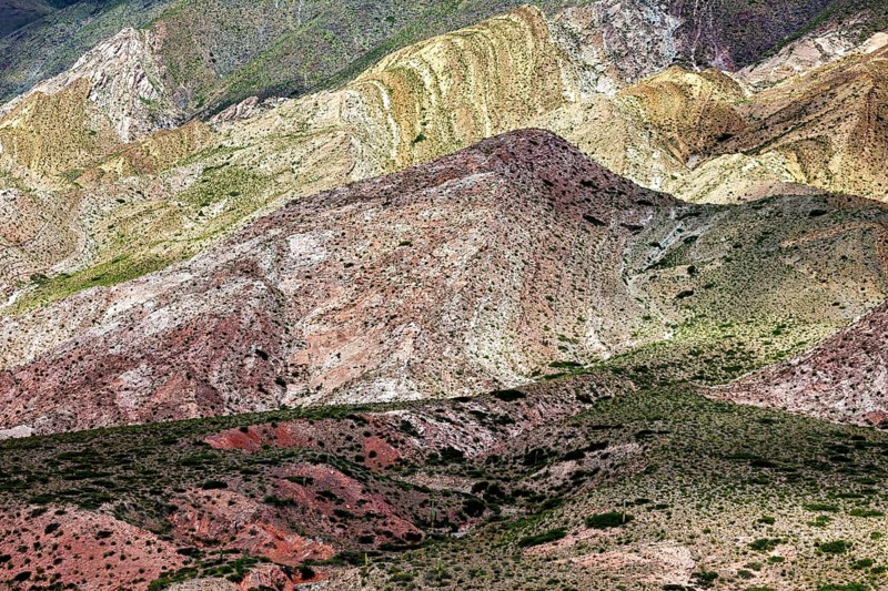 The picture shows colorful, diverse mountains with a wealth of natural colors and shapes, the landscape and colorful rock formations of the Quebrada de Cafayate near Salta in Argentina