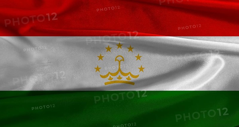 Flag of Tajikistan with fabric textured background. Close up of National flag of Tajikistan with realistic texture