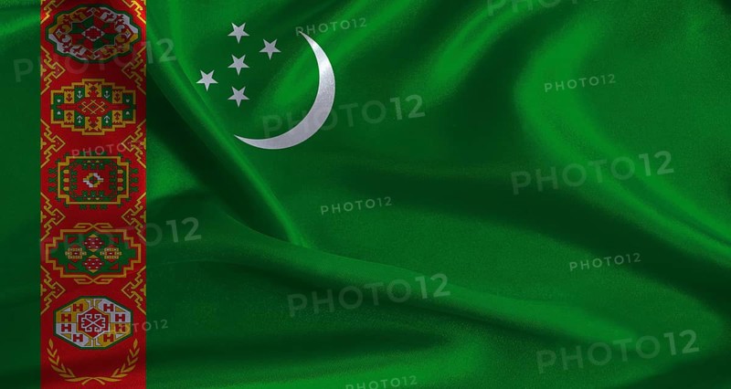 Turkmenistan flag with cloth textured background. National flag of Turkmenistan with realistic texture