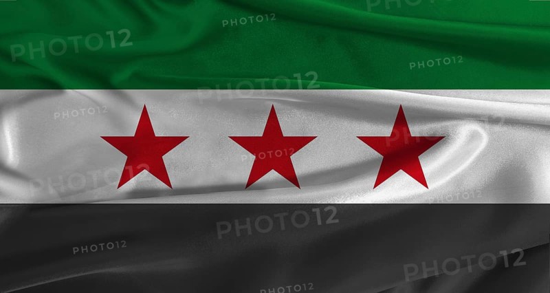 Flag of Syria with fabric textured background. Close up of National flag of Syria with realistic texture