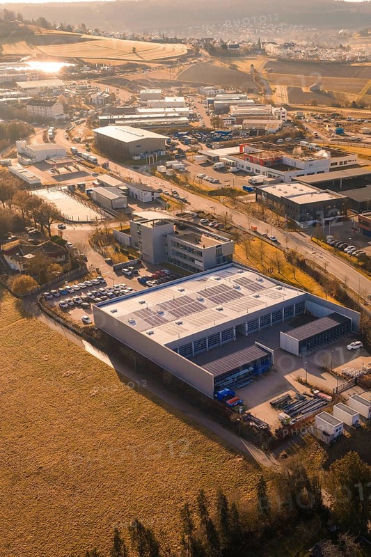 Aerial view of industrial landscape with buildings, fields and roads at sunset, Calw, Calw district, Germany